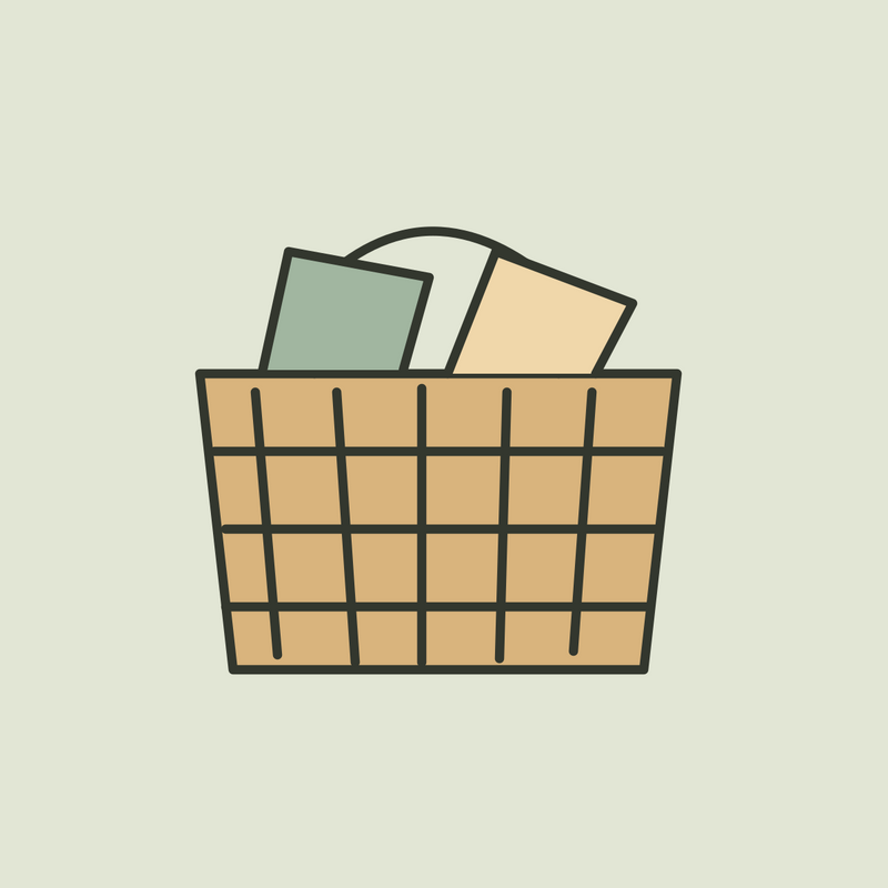 Illustration of a woven ochre storage basket holding sage and cream linens.
