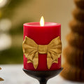 Luminara Flameless Candle 3.4" x 4.5" Real Wax w/Remote and Built-in Timer Moving Flame LED Battery Operated Holiday Red Pillar with Gold Bow Unscented Seasonal Christmas Decorations